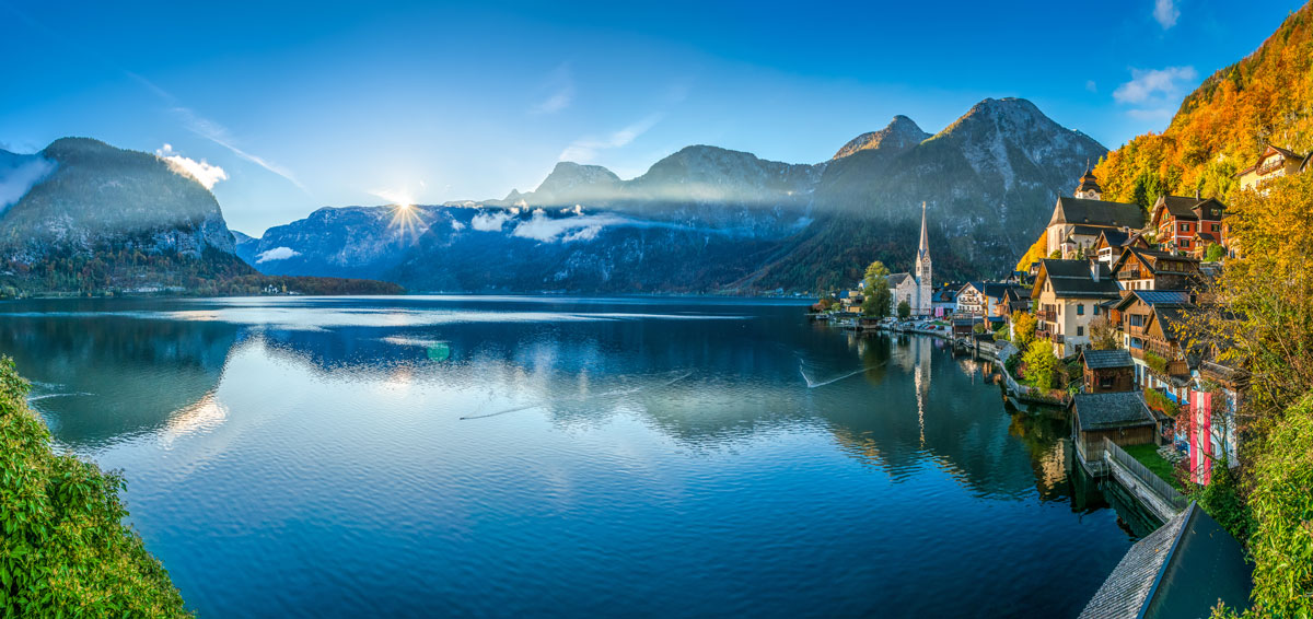 Hallstatt village and church on the shore of Lake Hallstatt beneath Alpine peaks, Austria