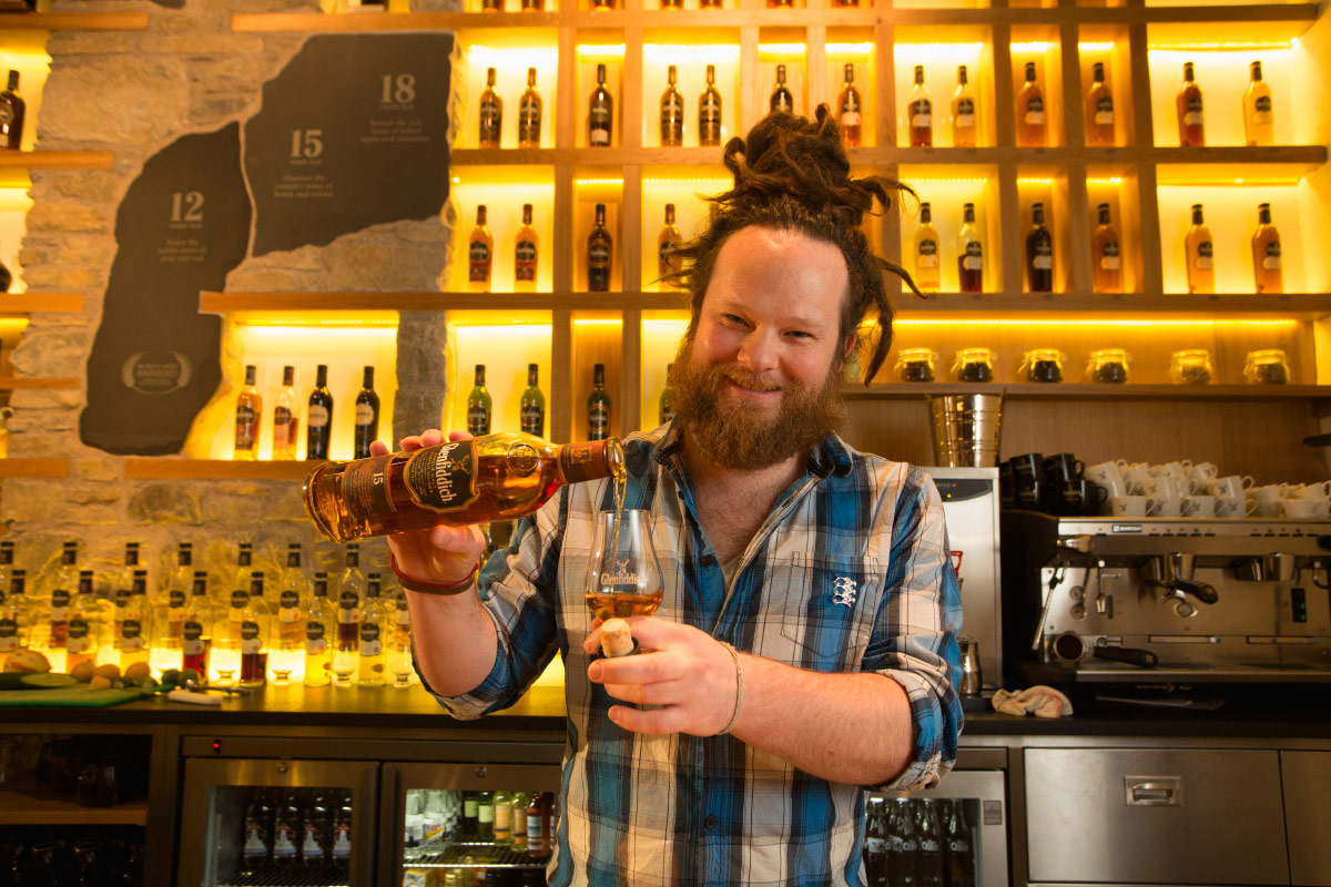 Man pouring drink at Scotch whisky festival