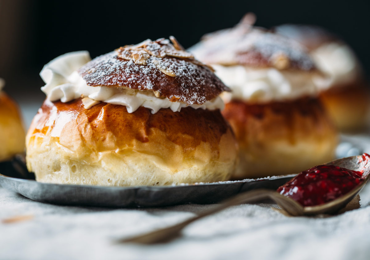 Semla bun with cream and icing sugar food bucket list