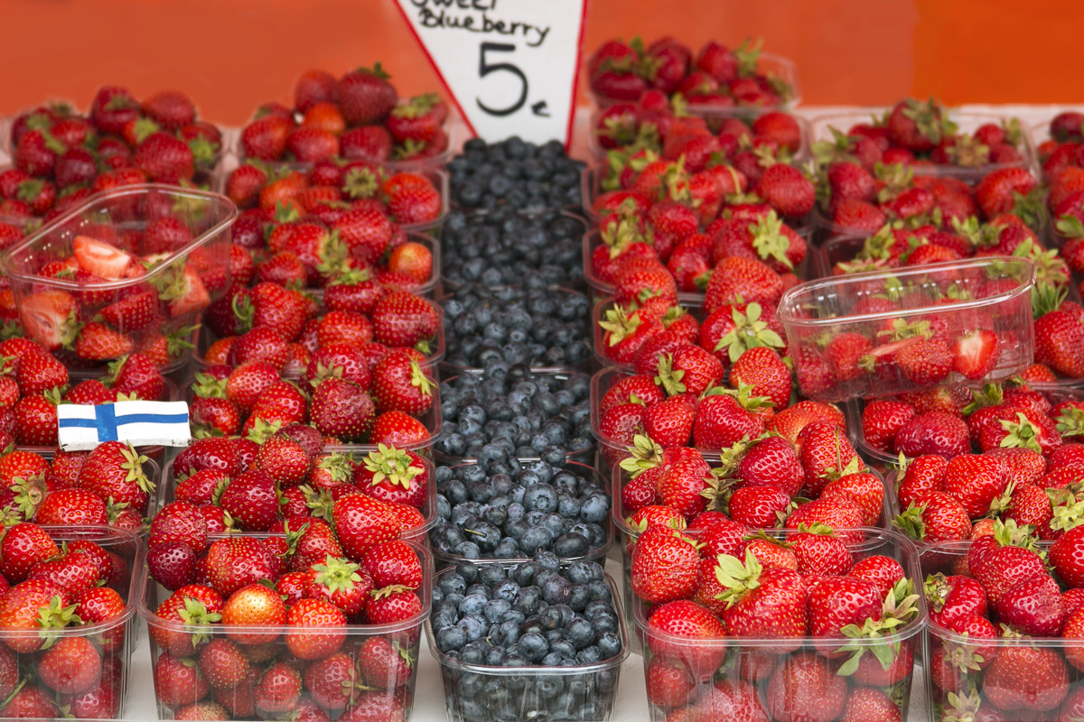 Punnets of fresh strawberries and blueberries at a market stall in Helsinki, Finland