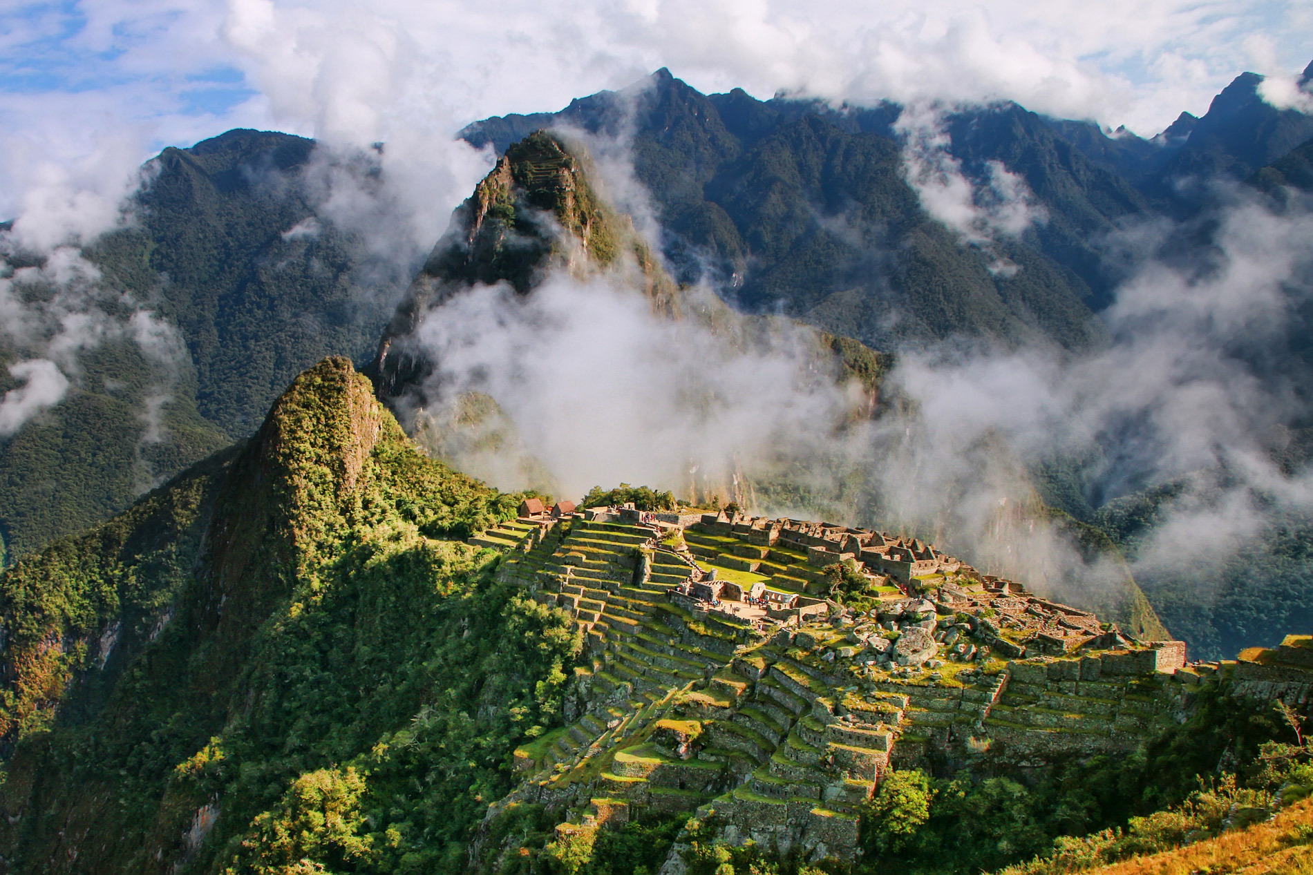 Machu Picchu Inca citadel and terraces beneath Huayna Picchu in the clouds, Peru