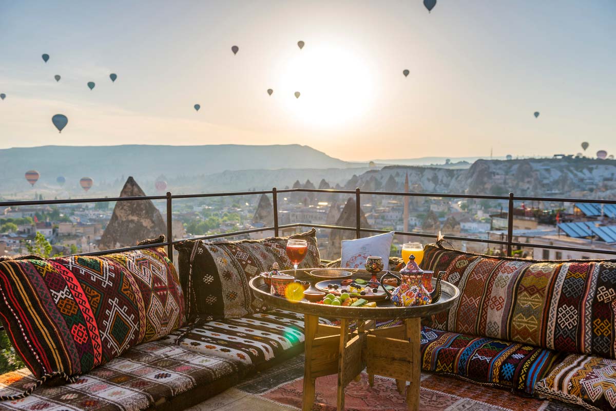 Traditional Turkish breakfast with the view of Cappadocia's hot-air balloons