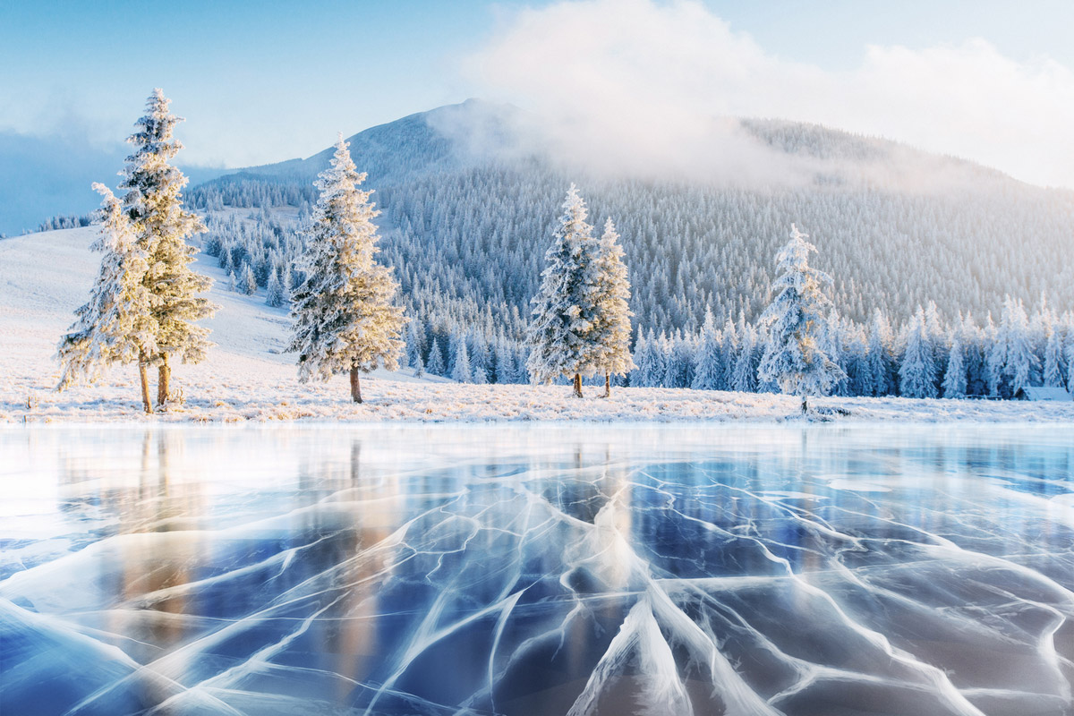 The famous blue ice appears in a frozen lake in the Carpathian Mountains