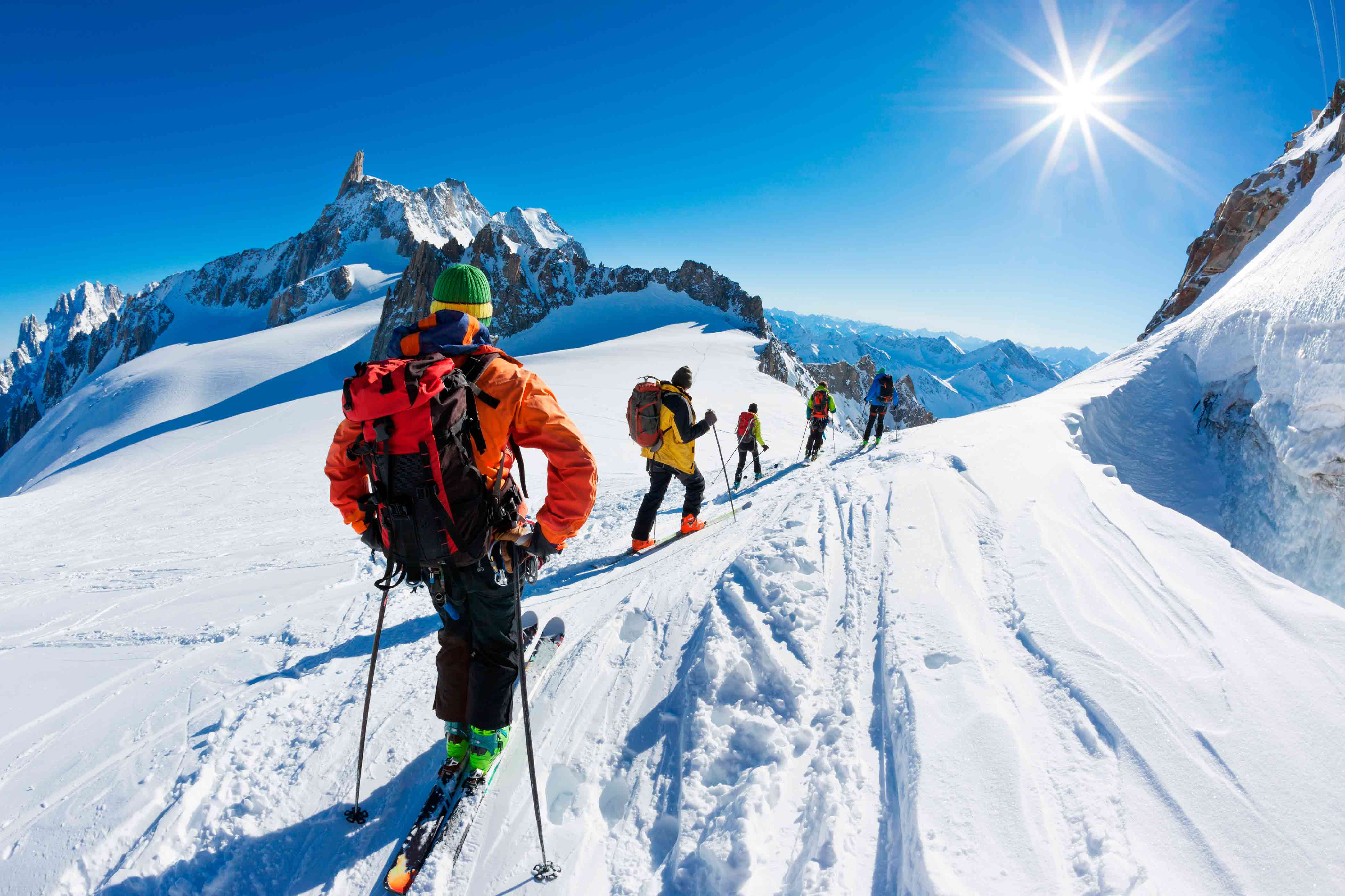 A group of skiers starting their descent off Valley Blanche