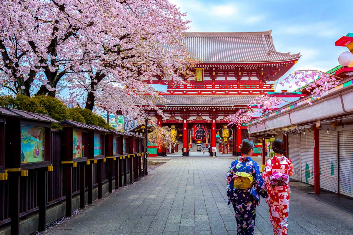 Two geishas wearing traditional japanese kimono among Sensoji Temple