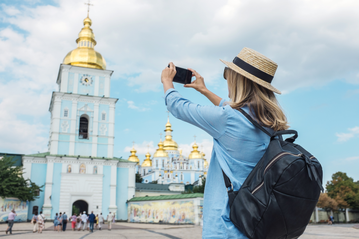Women taking photo of gold dome building in Kiev reasons to visit Kiev