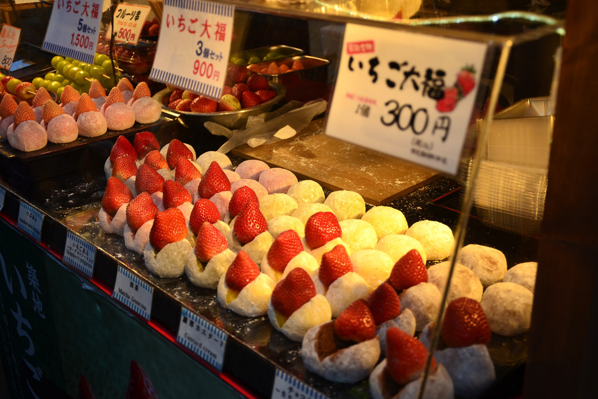 Strawberry daifuku and mochi for sale at a street food stall in Japan