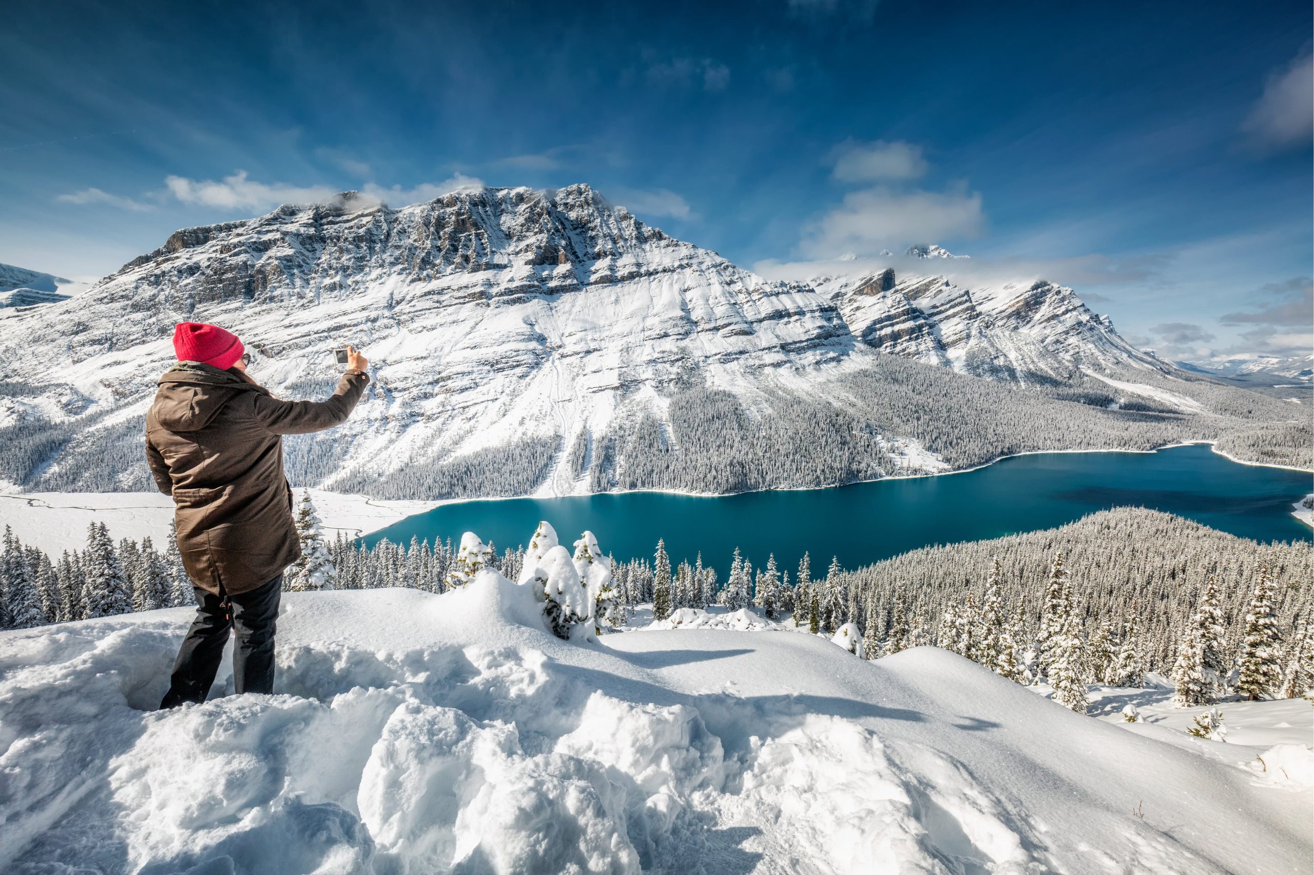Woman photographing winter landscape in Canada snow