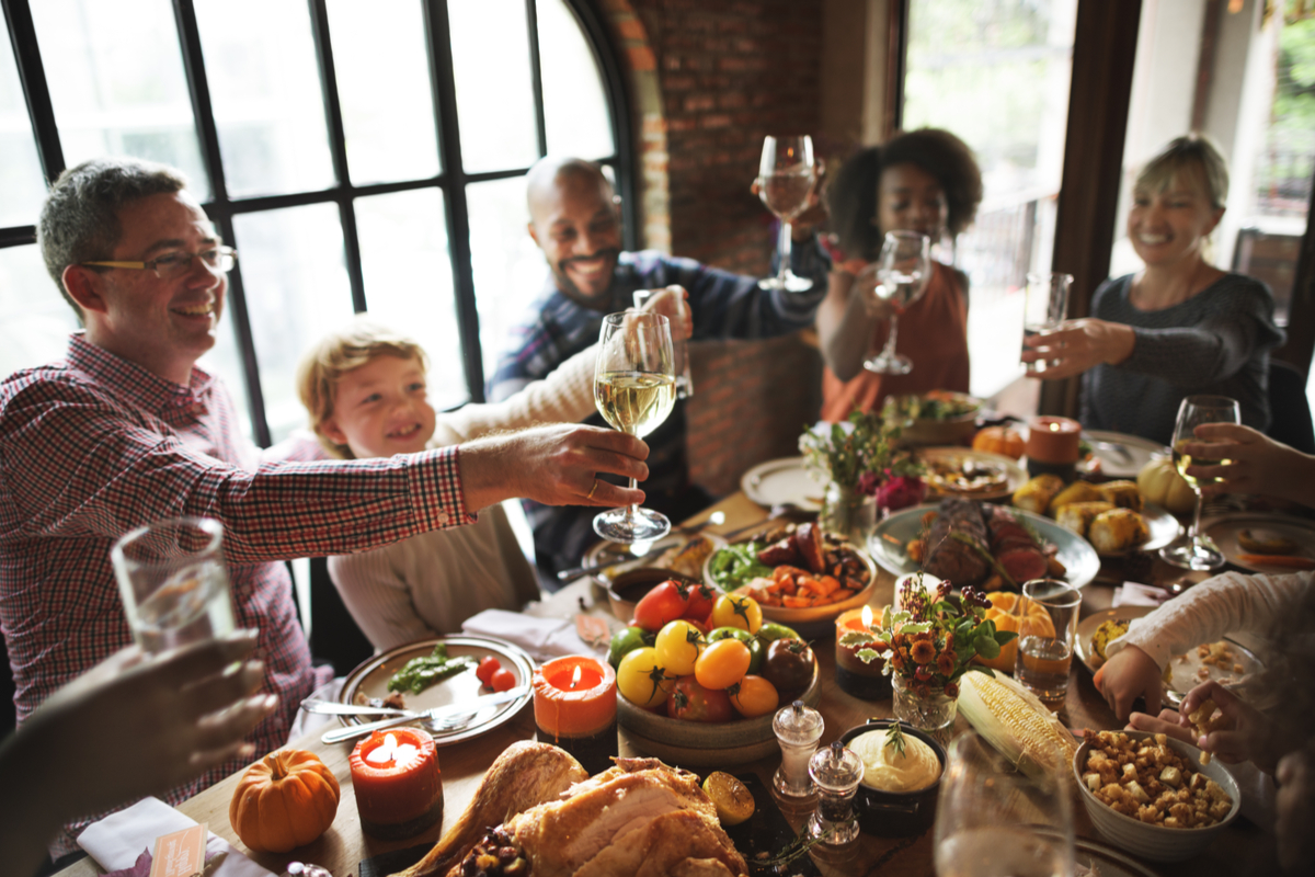 Family and friends cheers and enjoy dinner thanksgiving