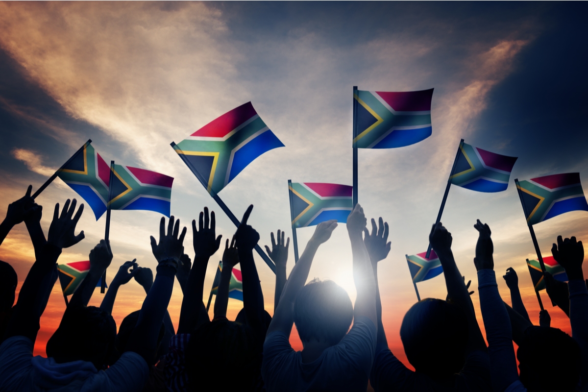 People waving south african flags at sunset South Africa