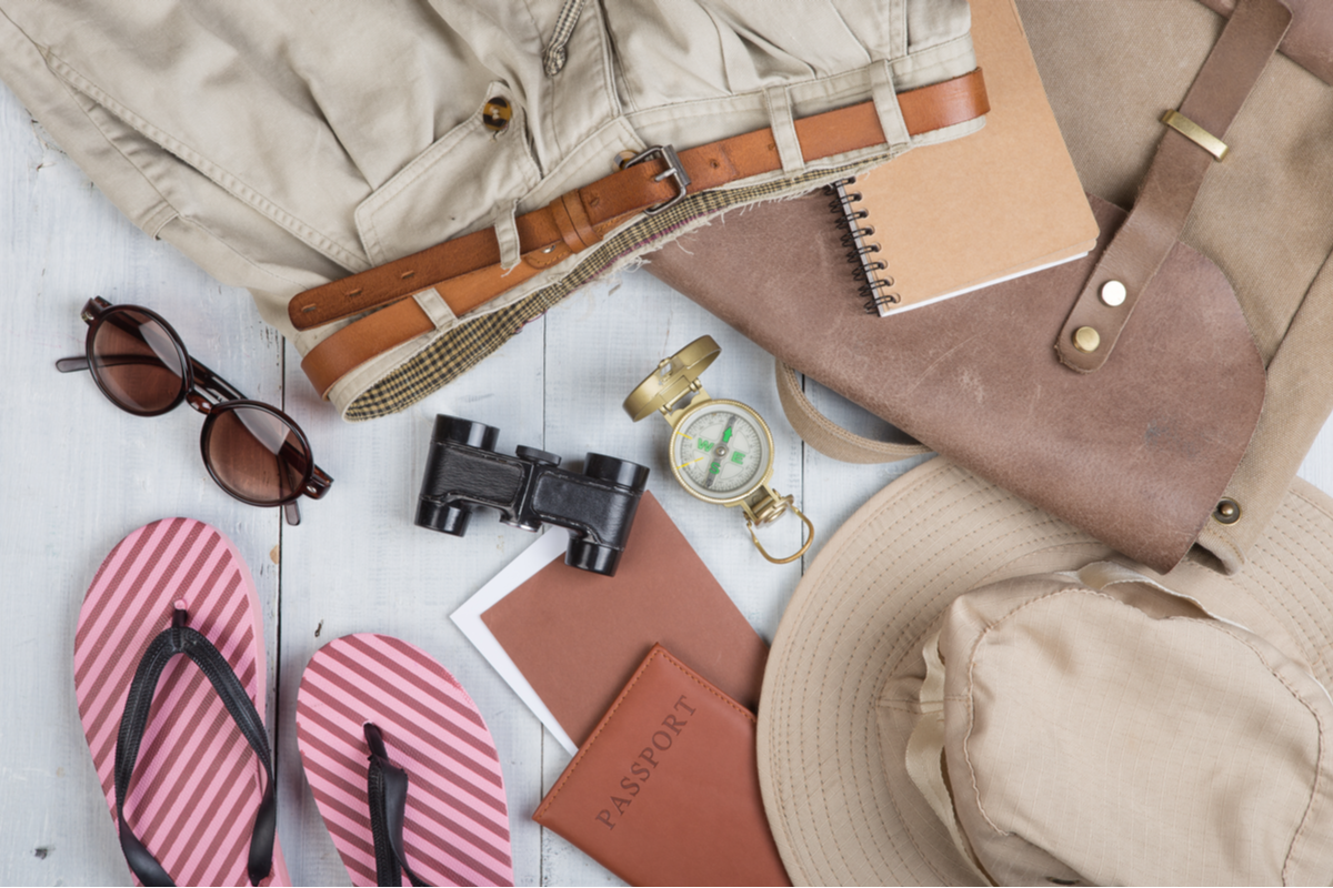 Flatlay of safari vacation luggage items
