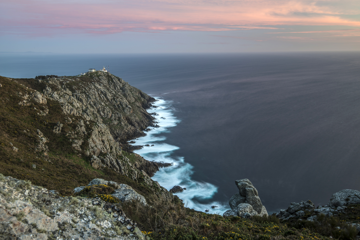View of lighthouse and cliffs at Cape Finisterre in Spain