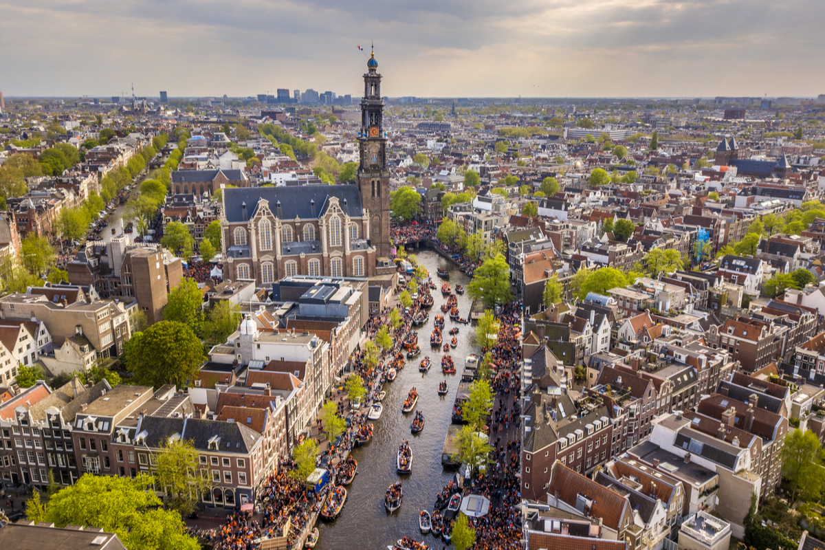 View of WestKerk and canals in Amsterdam on King's Day
