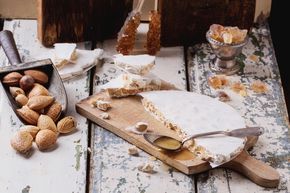 Table with Spanish turron and almonds World Baking Day