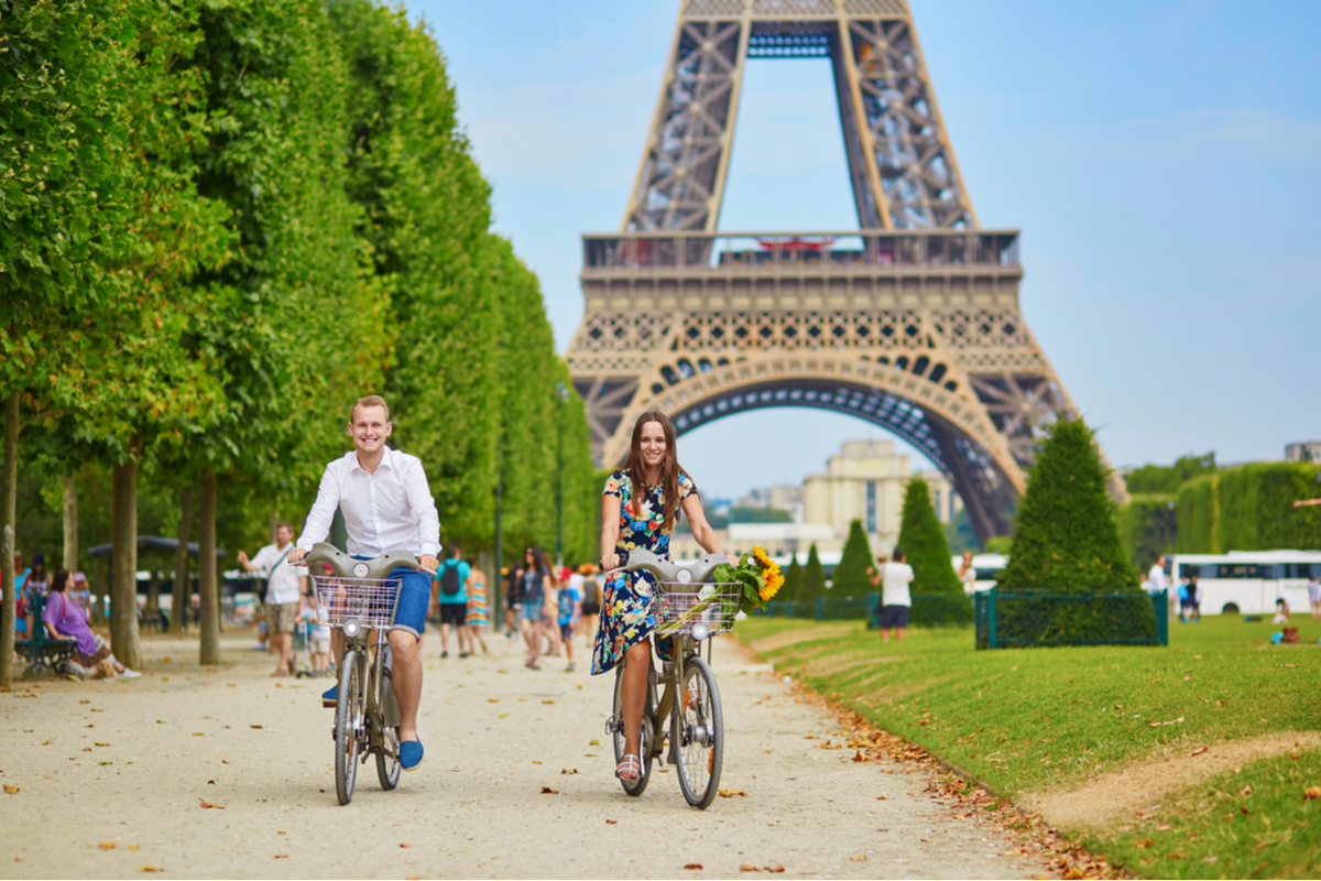 Couple riding bicycles in Paris France