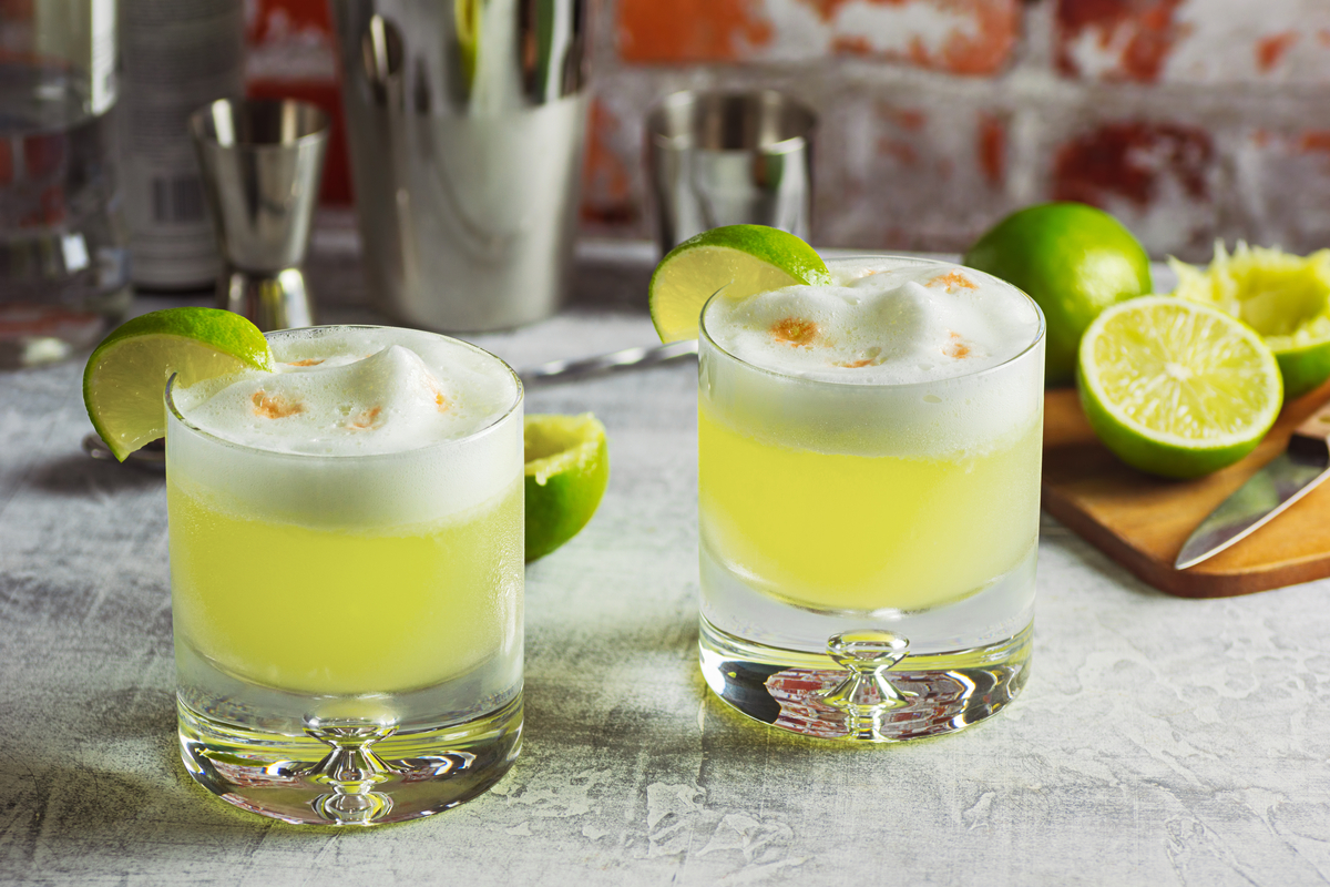 Two pisco sour cocktails on table