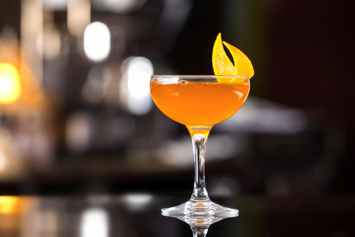 Sidecar with orange peel on bar counter cocktails