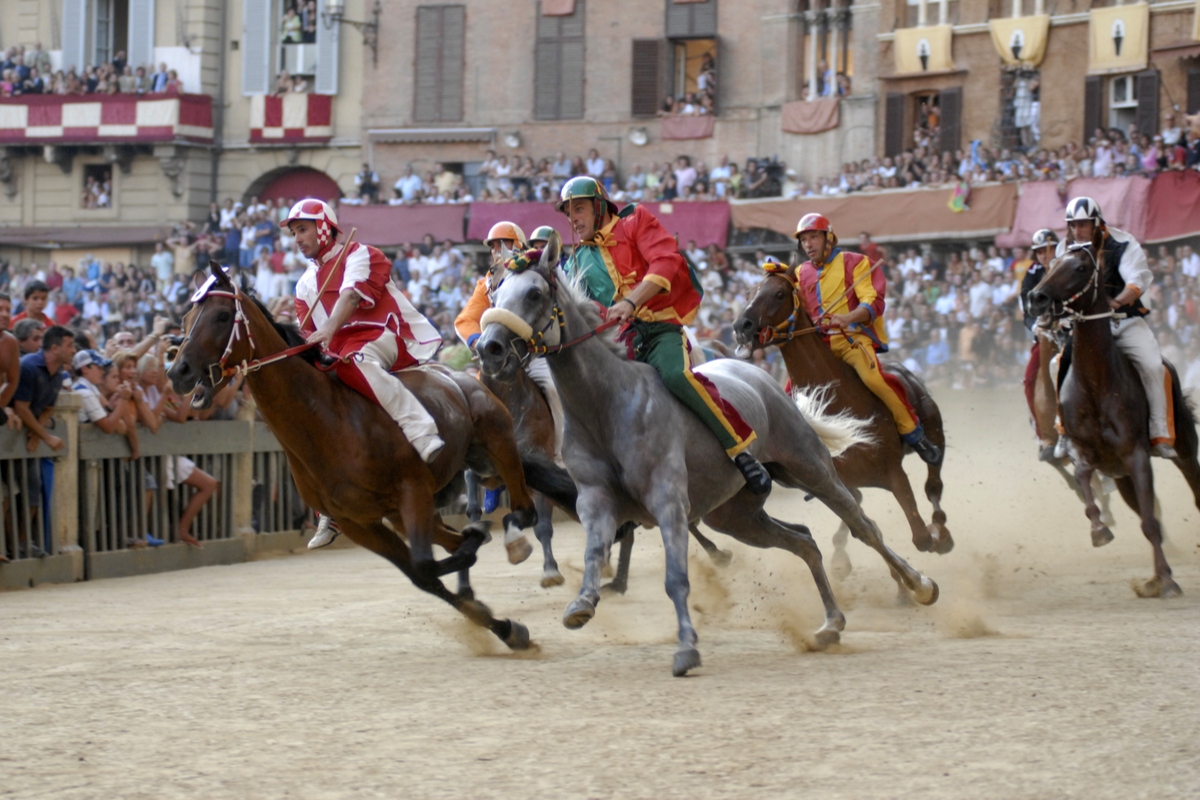 Jockeys and horses in Palio di Siena, one of the top Italian festivals