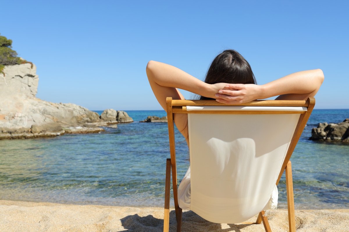 Woman relaxes on beach in Spain