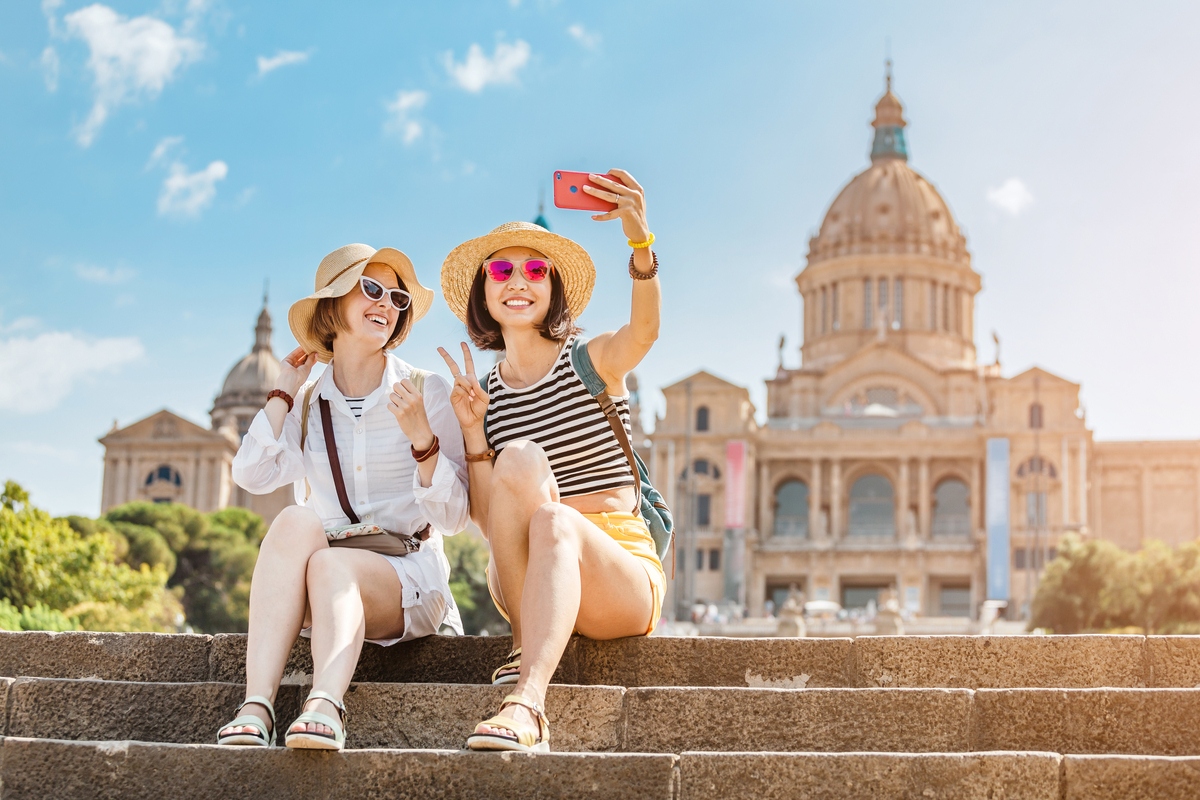 Two female tourists pose for a photo in Spain