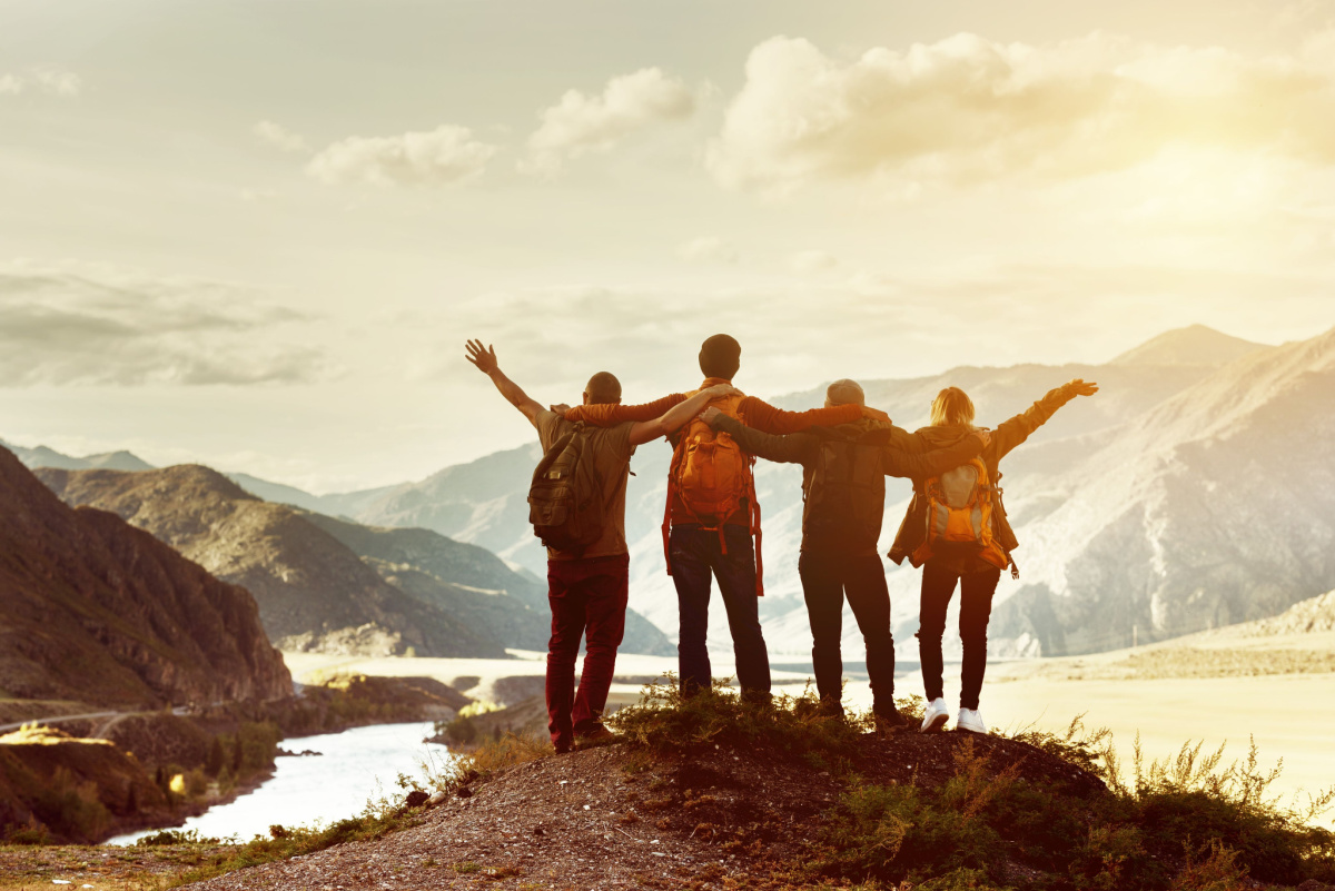 Friends hiking together on mountain, World Kindness Day
