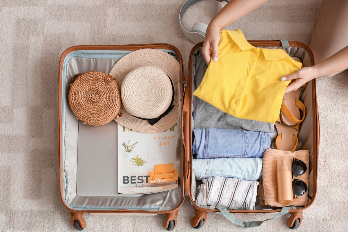 Traveller pakcing suitcase of essentials for rail tour