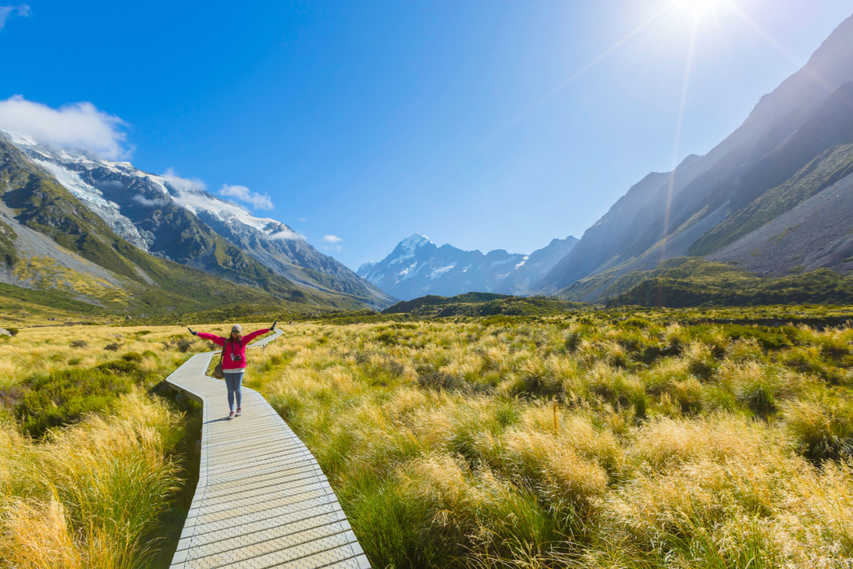 Happy solo traveller walking in mountains, 2023 trends
